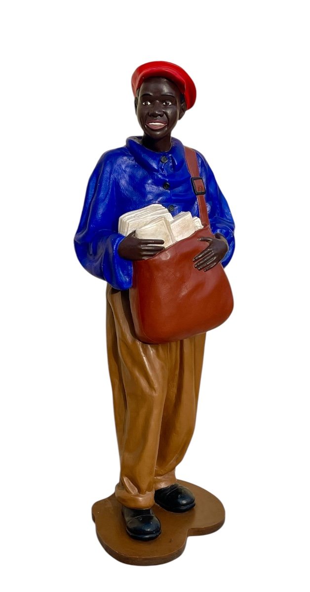 Statue Of A Young African Man Delivering Newspapers