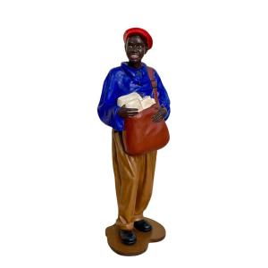 Statue Of A Young African Man Delivering Newspapers