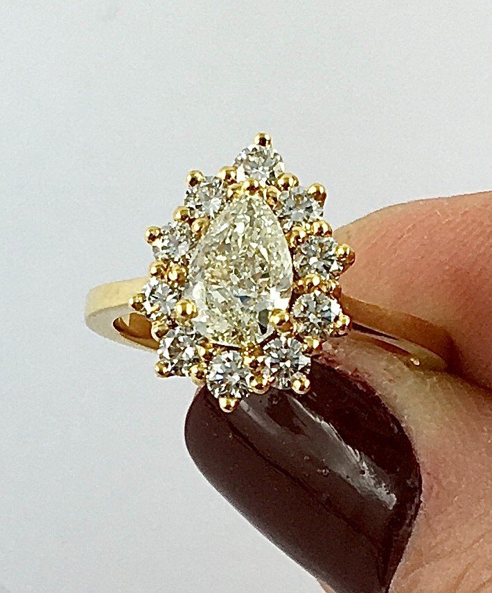 Pear Diamond Ring Surrounded By Diamonds On Yellow Gold-photo-7