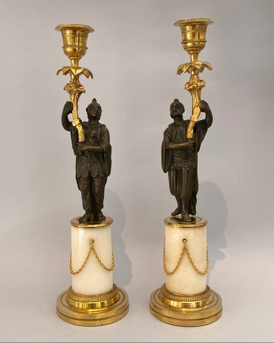 Pair Of Louis XVI Candlesticks With Chinoiserie, In Gilt And Patinated Bronze With Marble Base.