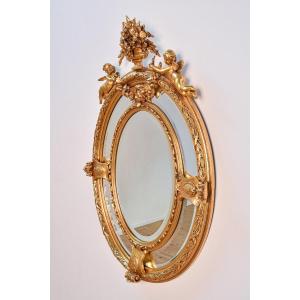 Baroque Oval Wooden Mirror (late 19th Century) Decorated With Putti And Floral Elements
