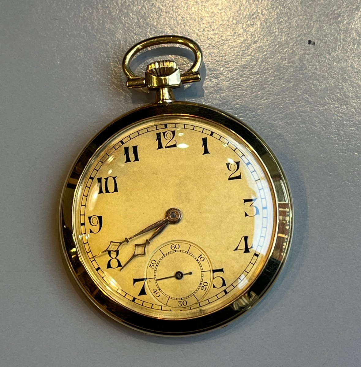 Gold Pocket Watch With Geometric Decoration.