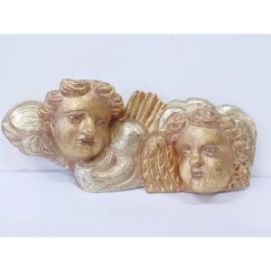 Deux têtes d'anges en bois doré.