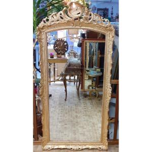 Grand miroir d'époque Régence en bois doré.