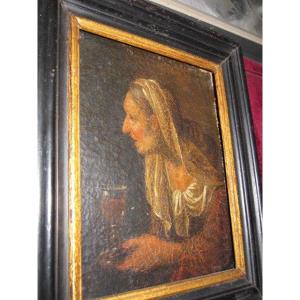 Old Woman With A Glass Of Wine. Small And Mysterious Canvas From The 17th Century.