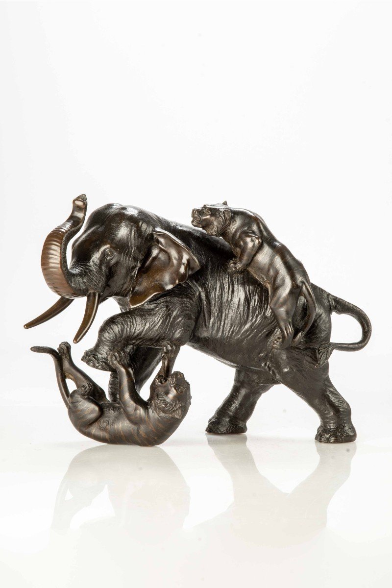 A Japanese Bronze Okimono Depicting An Elephant With Two Tigers