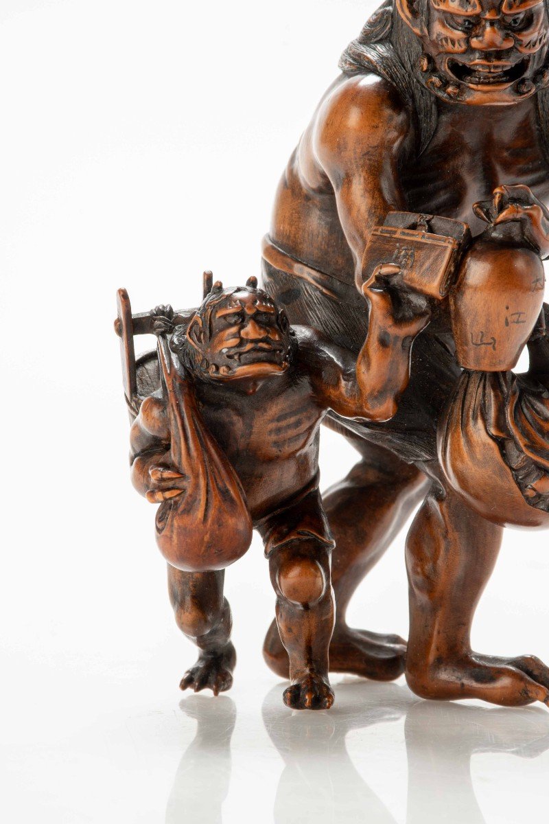 A Boxwood Okimono Depicting Two Walking Oni-photo-1