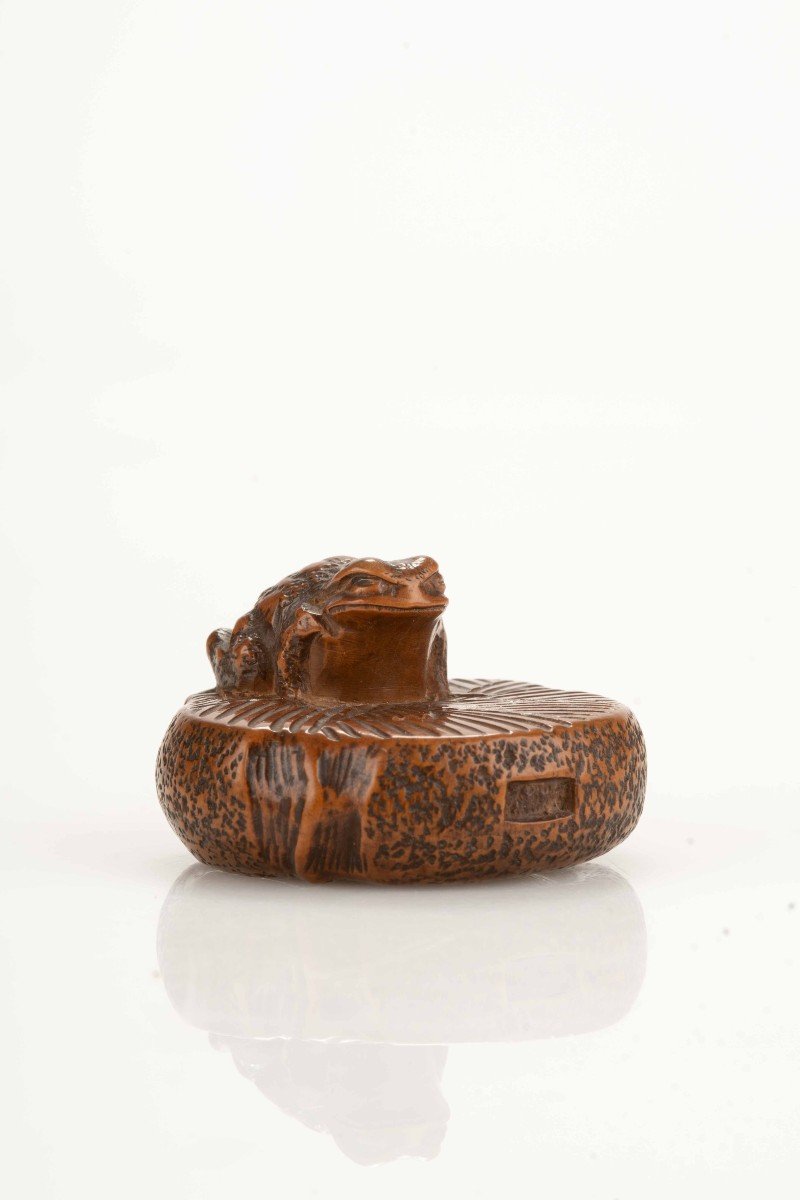 A Boxwood Netsuke Depicting A Toad On A Circular Stone Millstone, Signed Masanao