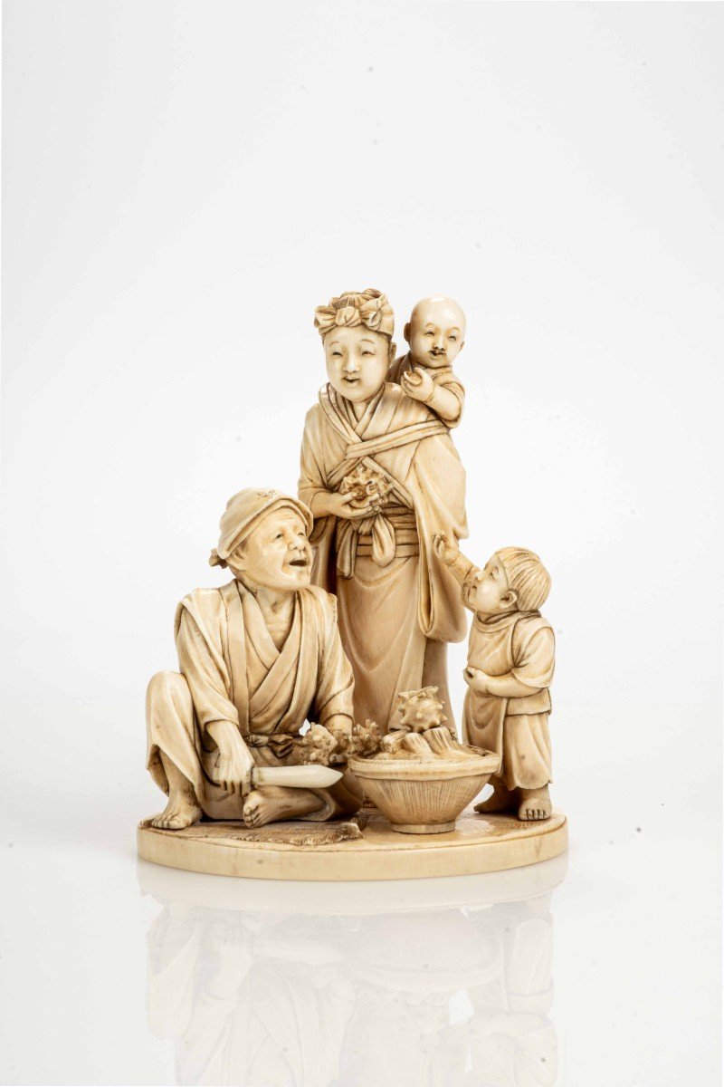 An Ivory Okimono Depicting A Seafood Vendor With His Family