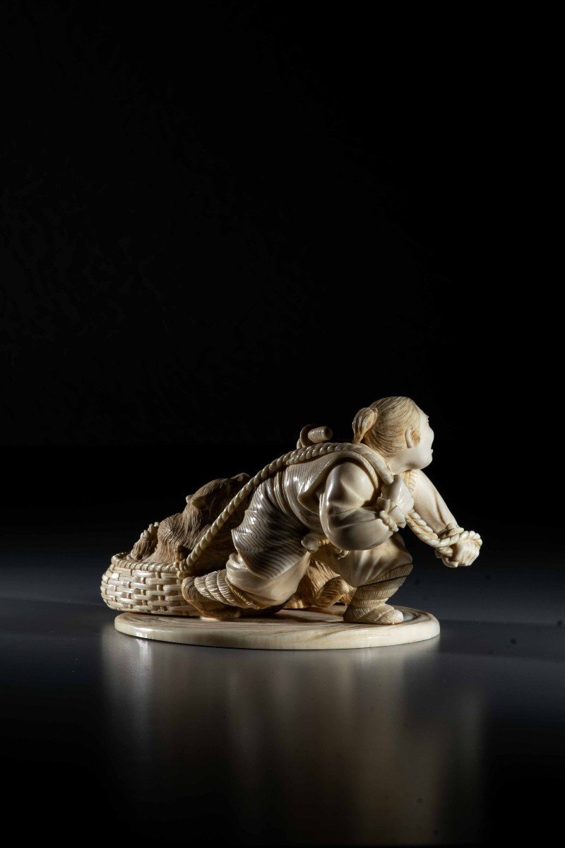 An Ivory Okimono Depicting An Ainu Hunter Dragging A Bear-photo-3