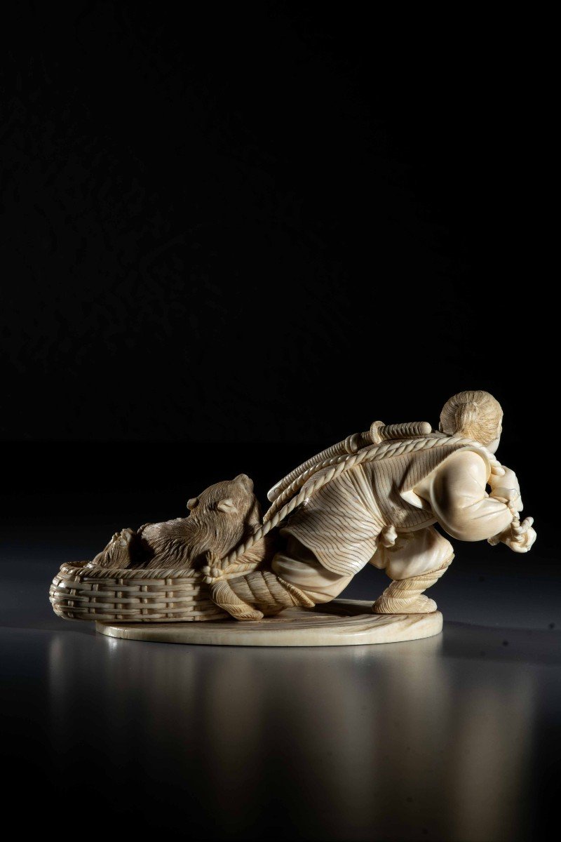 An Ivory Okimono Depicting An Ainu Hunter Dragging A Bear-photo-4