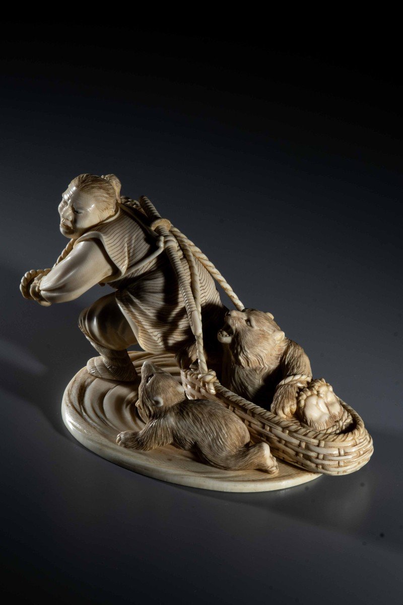 An Ivory Okimono Depicting An Ainu Hunter Dragging A Bear-photo-3