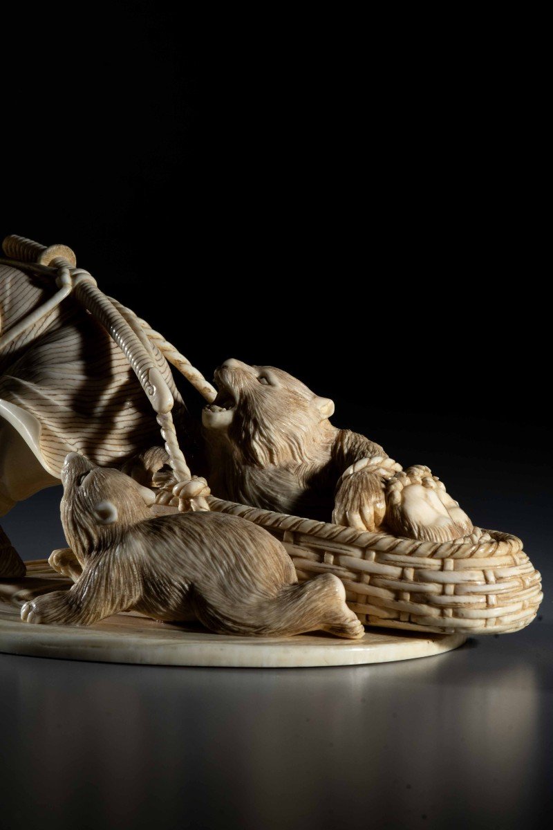 An Ivory Okimono Depicting An Ainu Hunter Dragging A Bear-photo-5