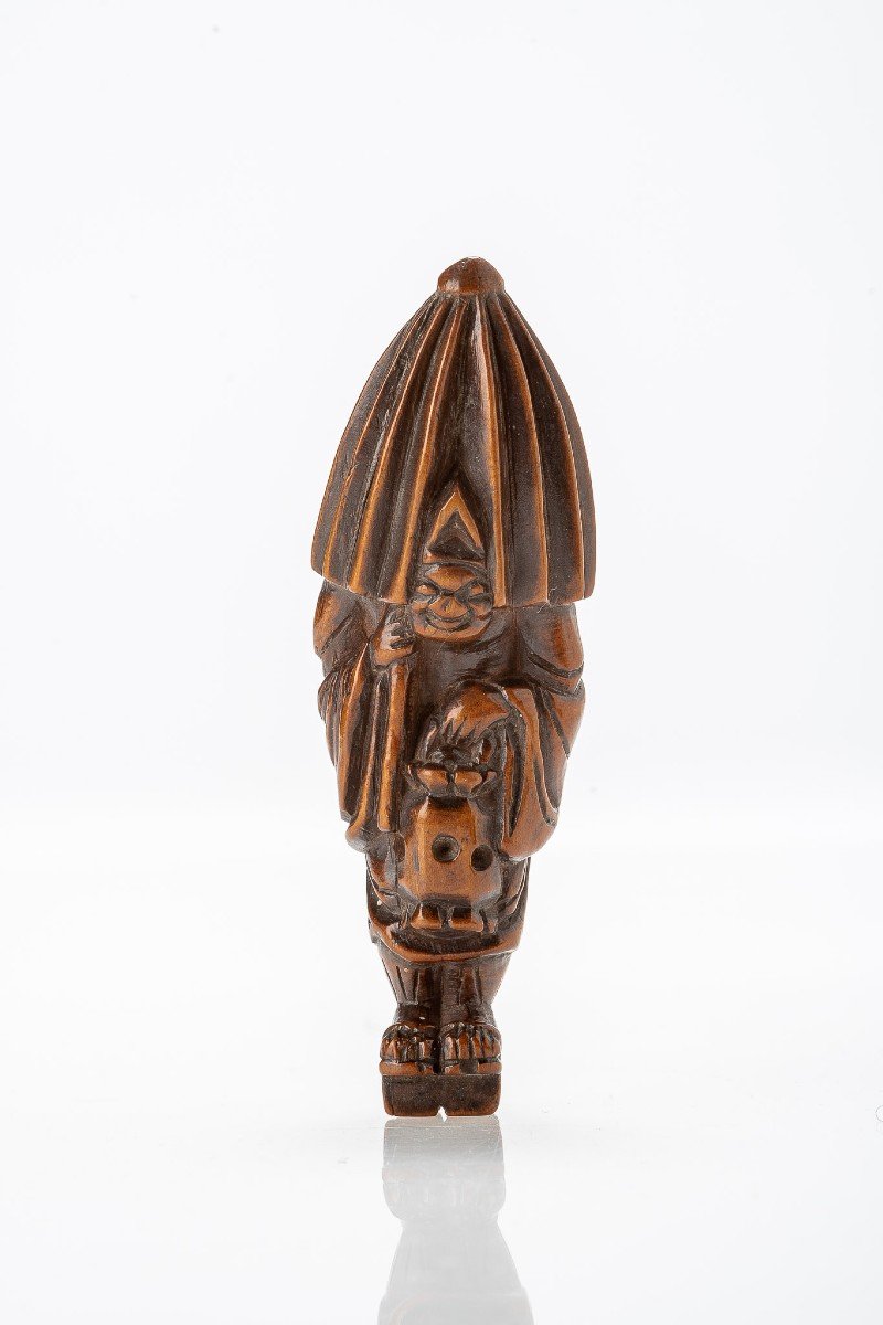 A Japanese Netsuke Of A Priest With Umbrella And Lantern