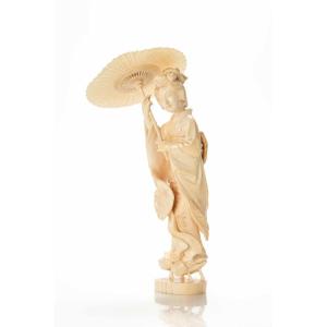 An Ivory Okimono Depicting A Walking Geisha