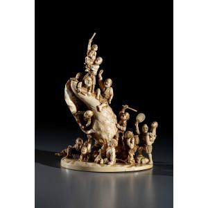 An Ivory Okimono Depicting Figures Around A Shell, Signed Kosuke