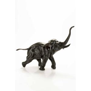 A Bronze Okimono Depicting A Running Elephant