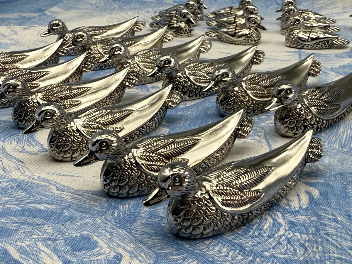 12 Knife Holders And 12 Name Holders In Silver Metal.