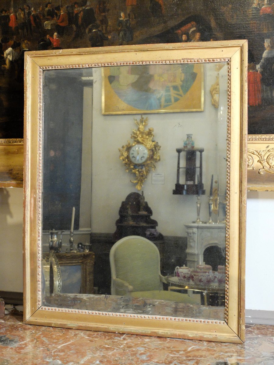 Miroir d'époque Louis XVI à fond de glace biseauté
