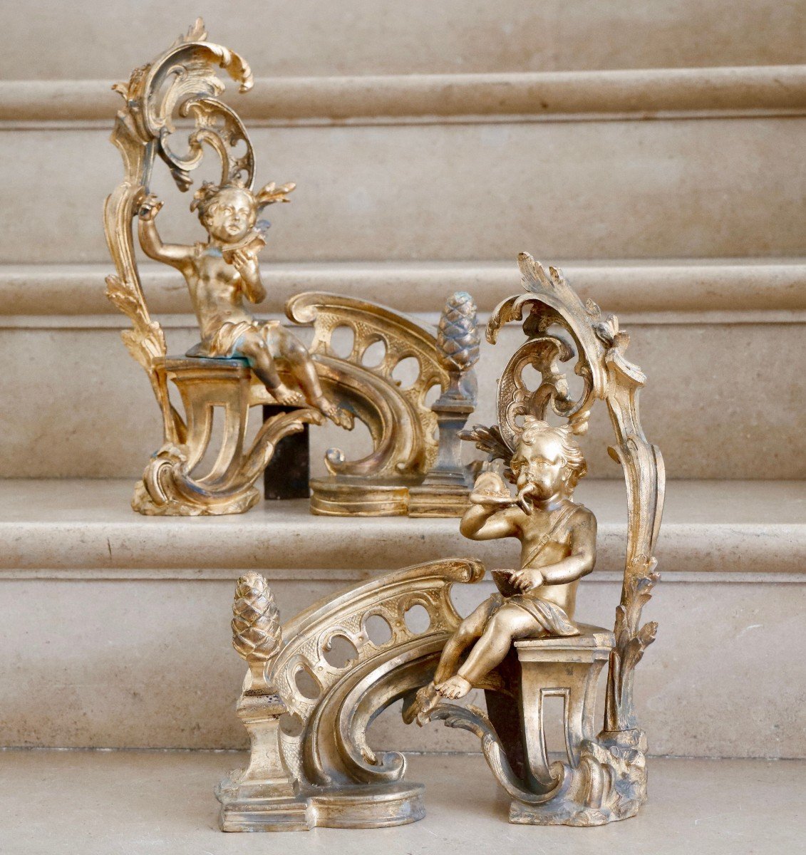 Pair Of Andirons With Putti In Gilt Bronze