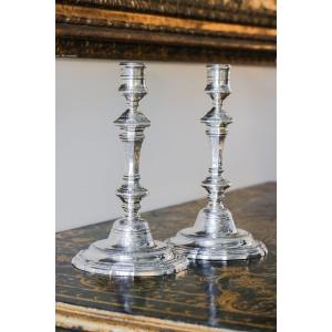 Pair Of Chiseled Silver Metal Candlesticks In The Shape Of A Baluster