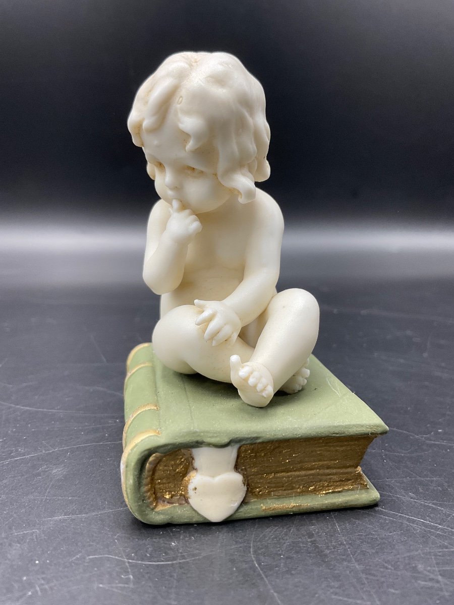 Biscuit From The Muller Factory Representing A Little Girl Sitting On A Book.-photo-2