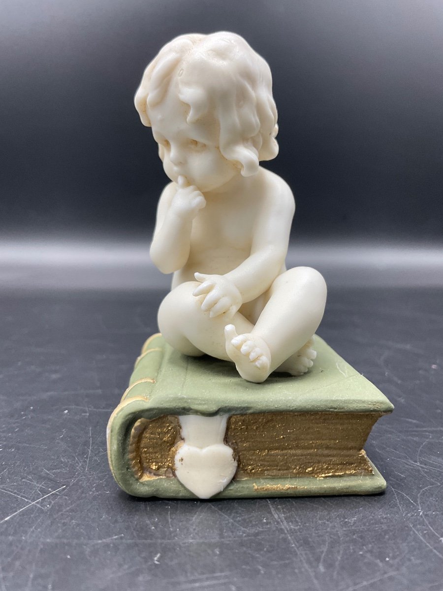 Biscuit From The Muller Factory Representing A Little Girl Sitting On A Book.-photo-2