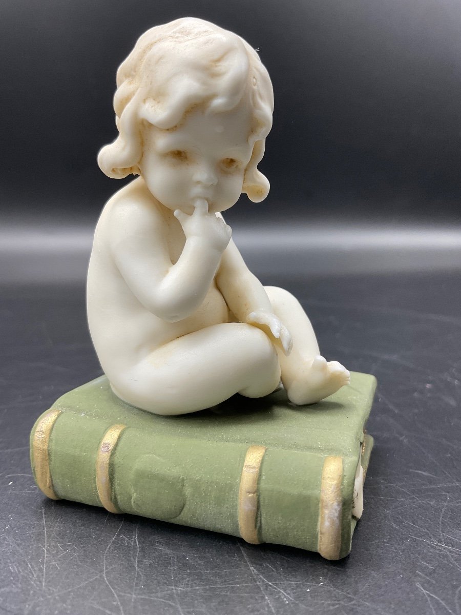 Biscuit From The Muller Factory Representing A Little Girl Sitting On A Book.-photo-3