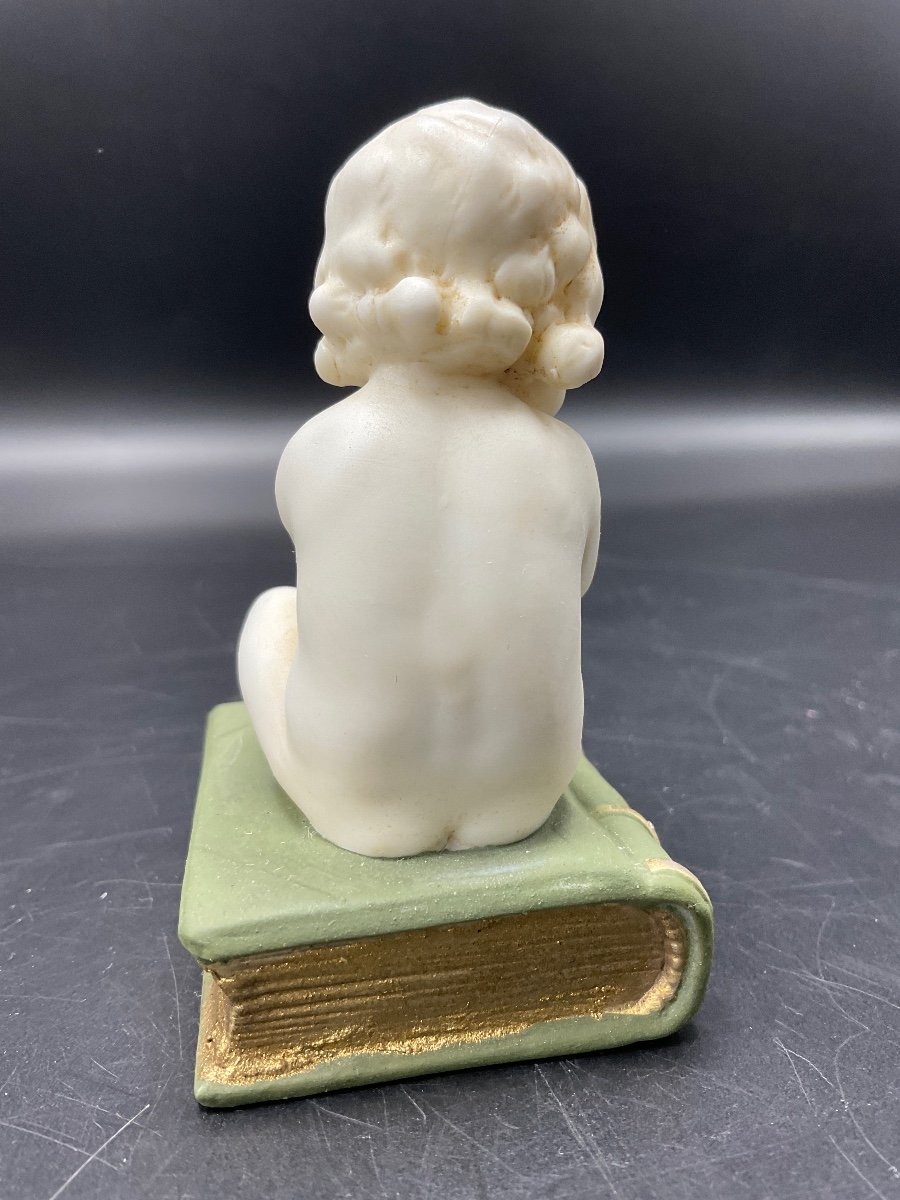 Biscuit From The Muller Factory Representing A Little Girl Sitting On A Book.-photo-4