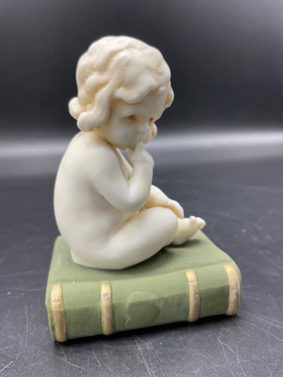 Biscuit From The Muller Factory Representing A Little Girl Sitting On A Book.-photo-5