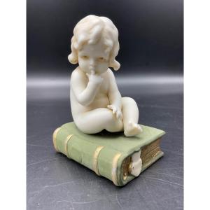 Biscuit From The Muller Factory Representing A Little Girl Sitting On A Book.