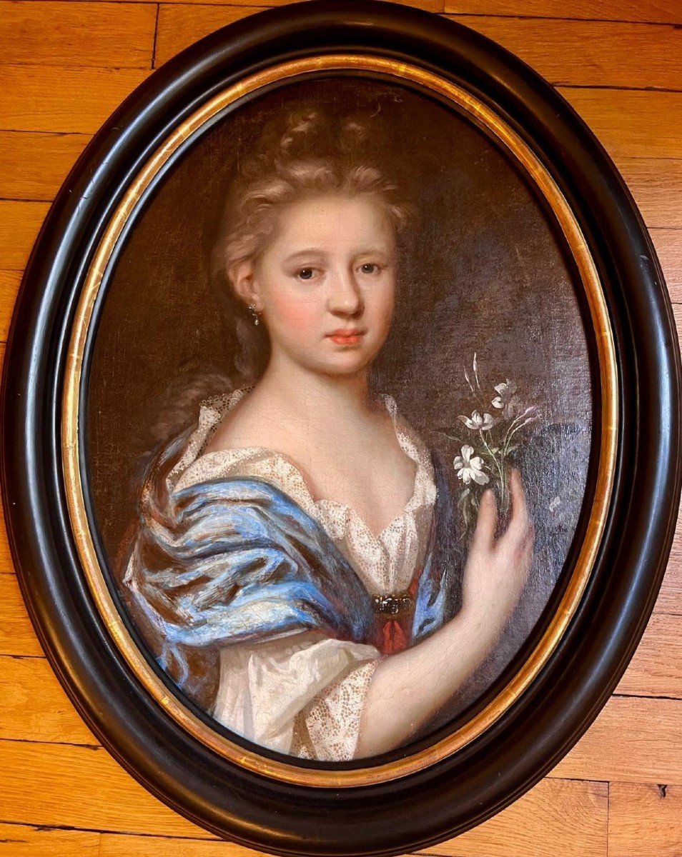 Portrait Of A Young Girl Holding A Bouquet Of Flowers