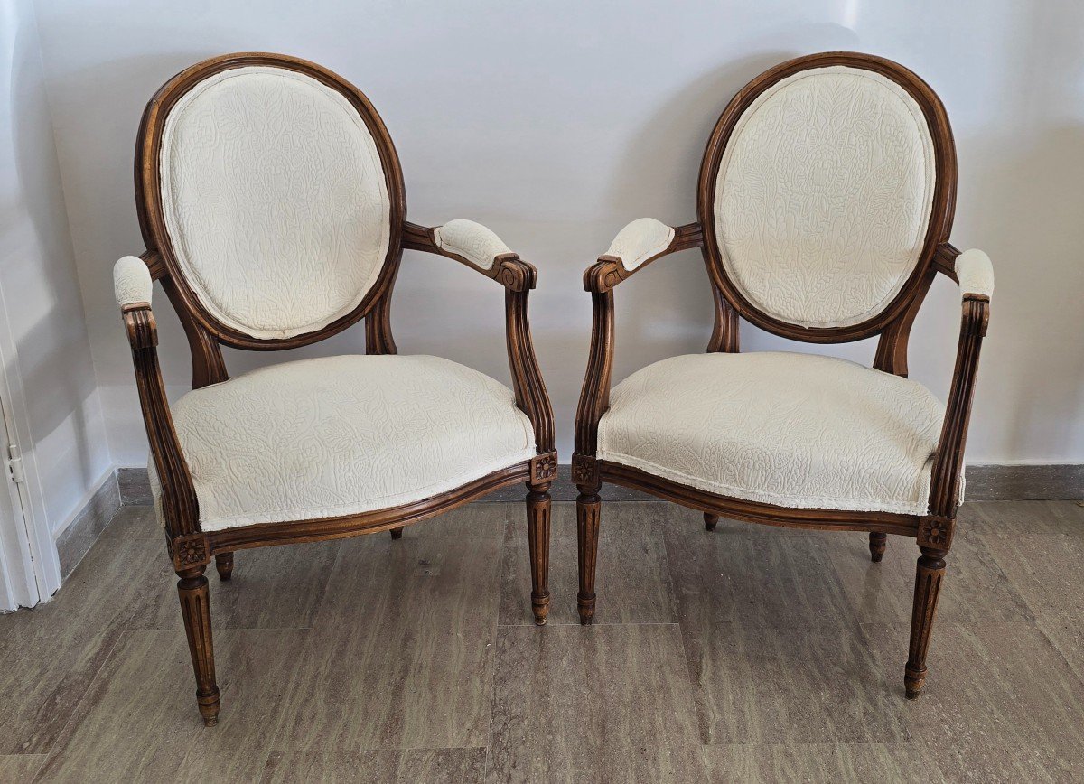 Pair Of Louis XVI Style Armchairs In Carved And Upholstered Walnut