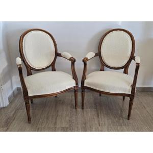 Pair Of Louis XVI Style Armchairs In Carved And Upholstered Walnut