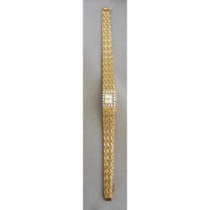 Uti Suisse (vers 1970). Montre Bracelet Dame Or Tour de bras 18k 750/1000 Et Diamants Poids Brut 37,80 grammes mouvement mécanique 