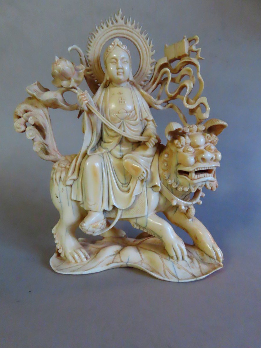 Ivory Okimono. Deity On An Fö Dog. China 1920-30.