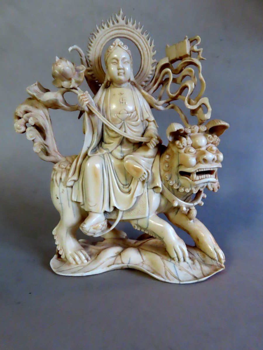 Ivory Okimono. Deity On Shishi. China 1920-30.