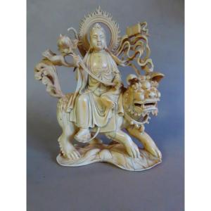 Ivory Okimono. Deity On An Fö Dog. China 1920-30.