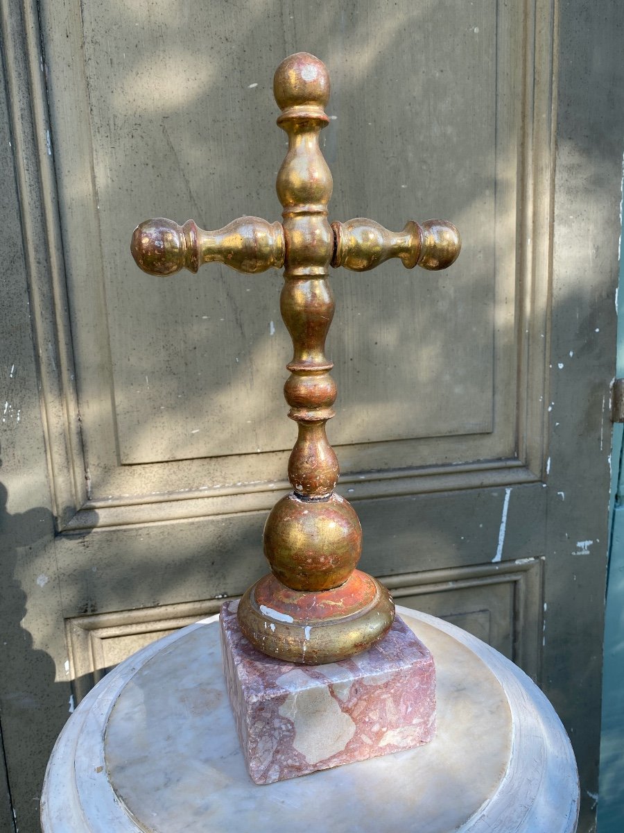 Golden Wooden Cross On Its Marble Base