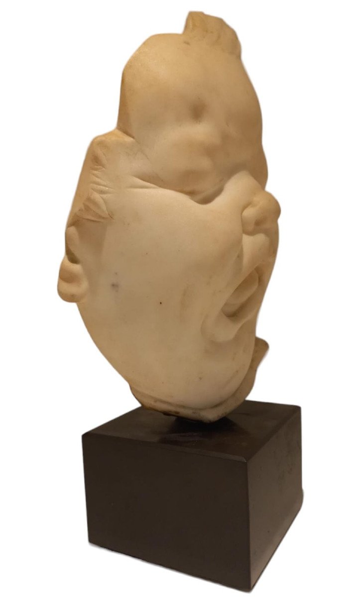 White Marble Sculpture Depicting The Face Of A Child With A Grimace-photo-3