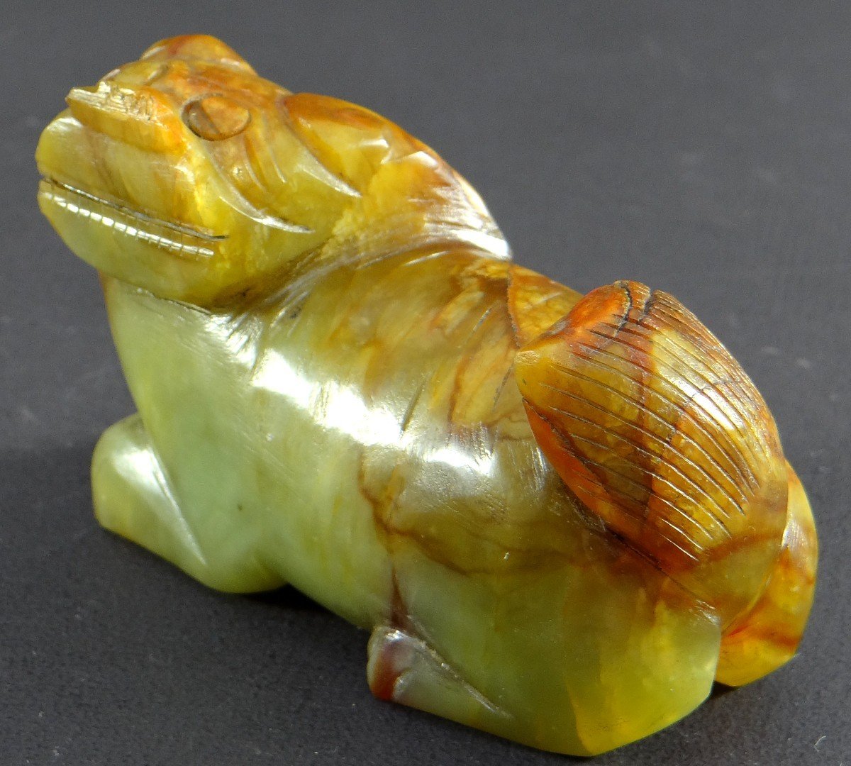 China, First Half Of The 20th Century, Small Buddhist Lion Statuette In Carved Jade. 