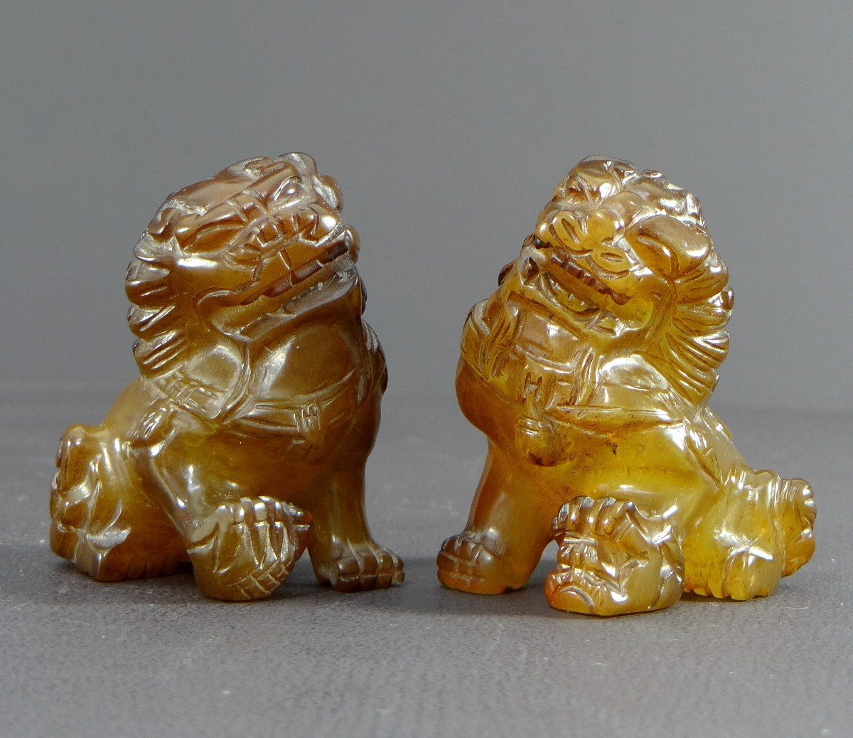 China, Mid-20th Century, Pair Of Fo Dogs In Hard Stone In The Spirit Of Agate.