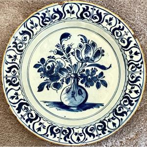 Delft, 18th Century, Earthenware Dish Decorated With Flowered Bottle Vase.