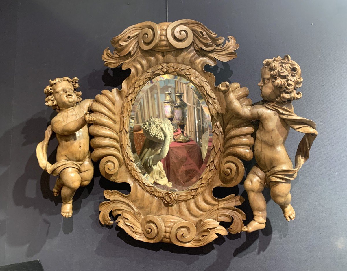 Large Mirror In Natural Wood Carved With Two Putti. South Of Italy. 18th Century.