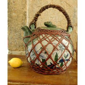 Very Large Porcelain Teapot Surrounded By A Basketwork Net. Japan. Late 19th Century.