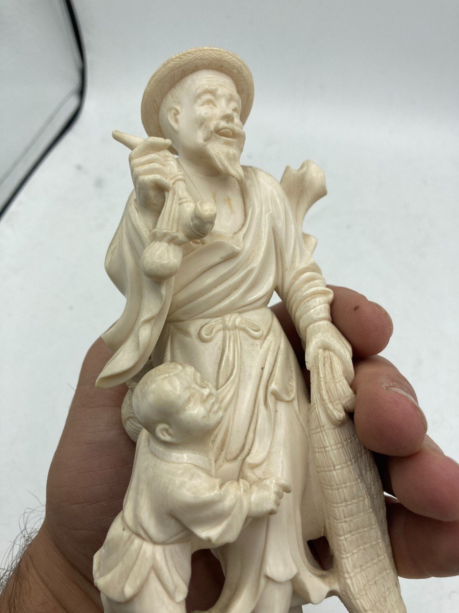 Ivory Sculpture Representing A Man And A Child -photo-1